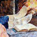 A fabric collage depicting a pair of feet at rest on a gray ottoman in warm cream colored socks. There is a book open on ottoman and fire burning in the fireplace beyond.  A pink blanket is nearby.